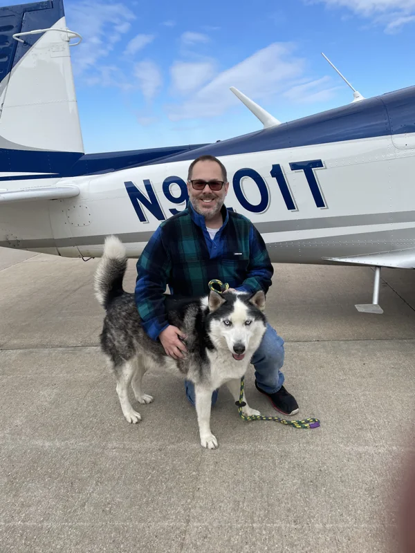 Apollo with pilot beside an airplane